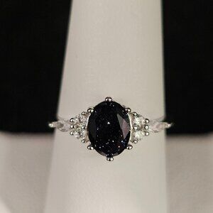 Beautiful black sparkling oval stone in sterling silver ring. Size 9